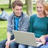 Young professionals looking at a computer